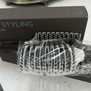 Two new, boxed hair brushes. Unique design for added comfort.